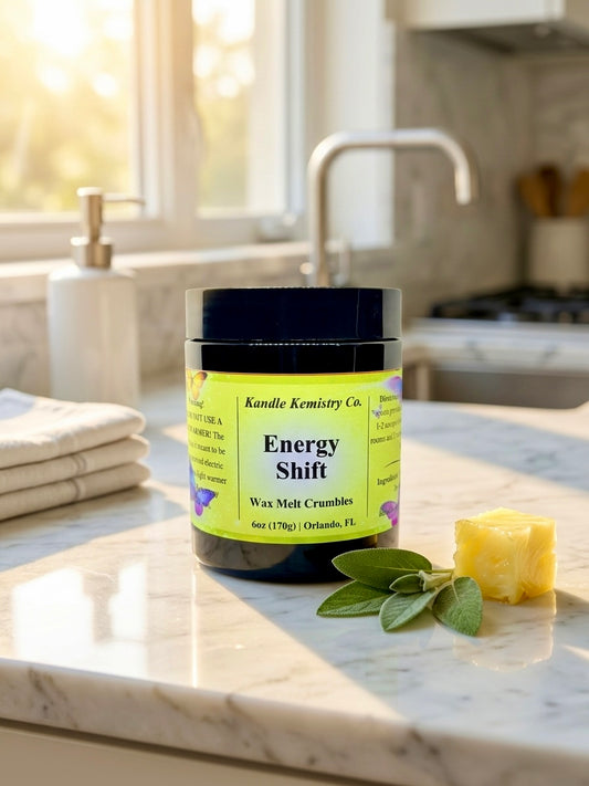 Jar of 'Energy Shift' wax melt crumbles on a kitchen counter with sunlight streaming in.