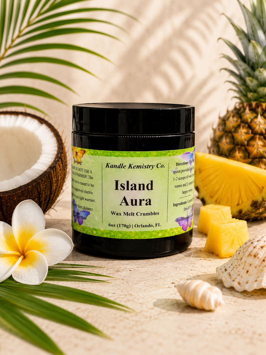 Island Aura wax melt crumbles jar styled with pineapple, coconut, and tropical elements for a Coconut Colada inspired home fragrance