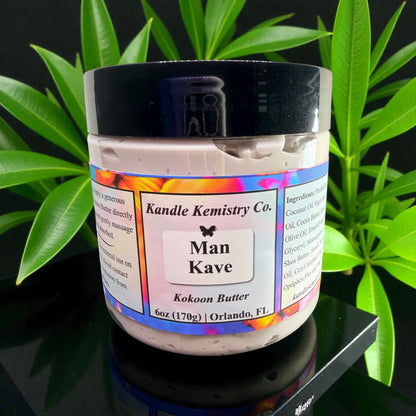 Jar of Kandle Kemistry Co. Man Kave Kokoon Butter with a colorful label against a green leafy background