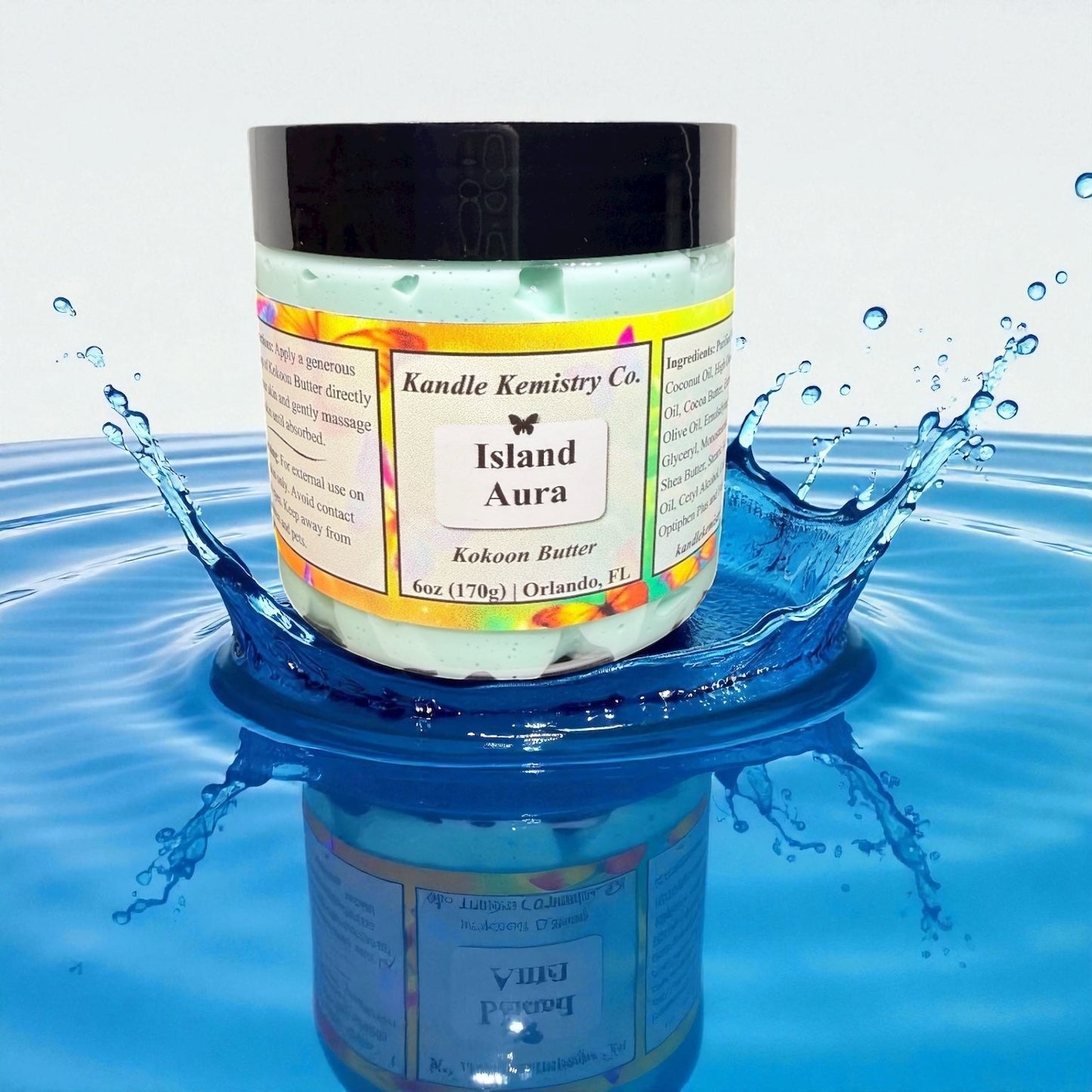 Jar of 'Island Aura' body butter product by Kandle Kemistry Co. on a blue water surface