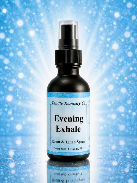 A bottle of Evening Exhale Room & Linen Spray by Kandle Kemistry Co. The product is in a black glass bottle with a black spray pump and a light blue and white label, set against a blue sparkling background with a reflection below.