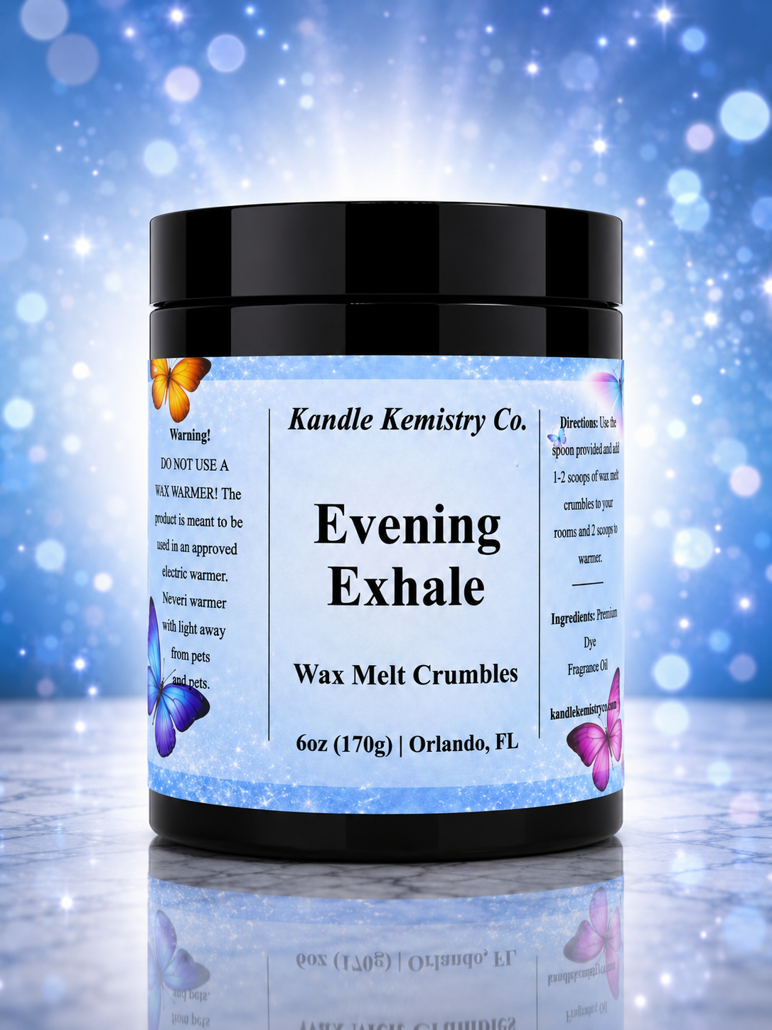 A jar of Kandle Kemistry Co. Evening Exhale Wax Melt Crumbles, 6 oz, featuring a black lid and a light blue label with butterfly illustrations, set against a sparkling blue bokeh background.