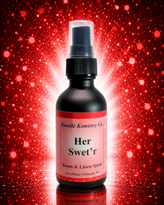 A 2oz spray bottle of Kandle Kemistry Co. 'Her Swet'r' Room & Linen Spray, set against a red glitter background with a bright white glow behind the bottle.