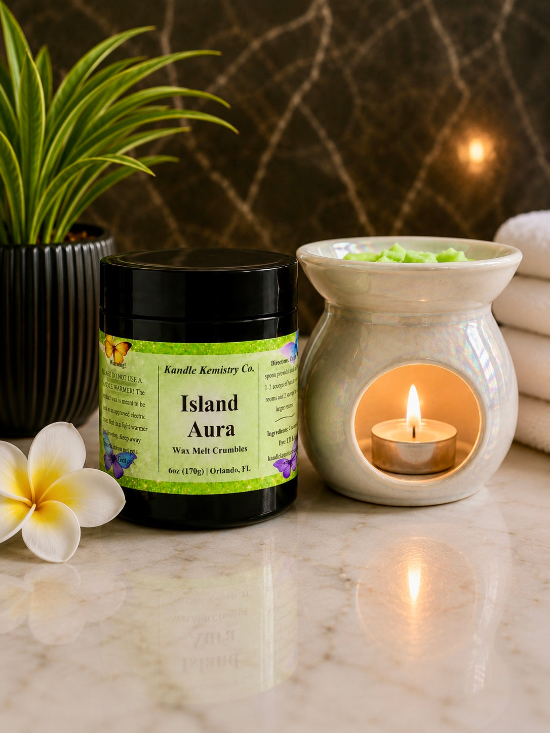 Island Aura wax melt crumbles next to wax warmer in spa-like setting, creamy coconut and fruit fragrance for relaxing home atmosphere