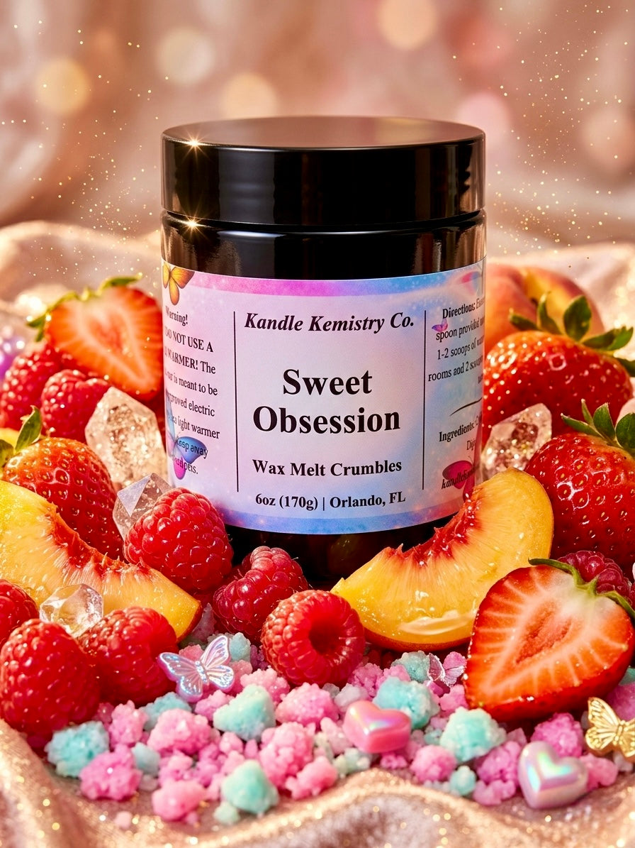 Jar of 'Sweet Obsession' wax melt crumbles surrounded by strawberries and candy on a glittery background