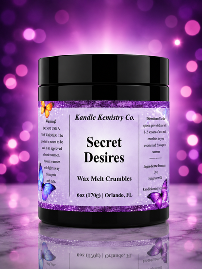 A jar of Kandle Kemistry Co. 'Secret Desires' wax melt crumbles, featuring a black lid and a purple glittery label with butterfly illustrations, set against a purple bokeh background.